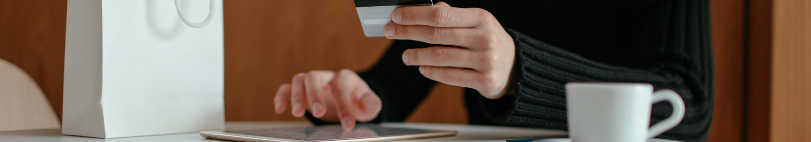 A person using their card and a tablet