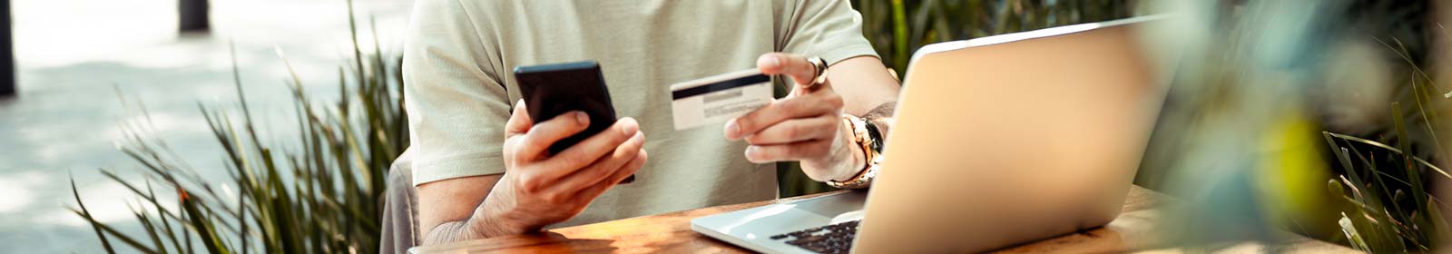 hands holding card and phone