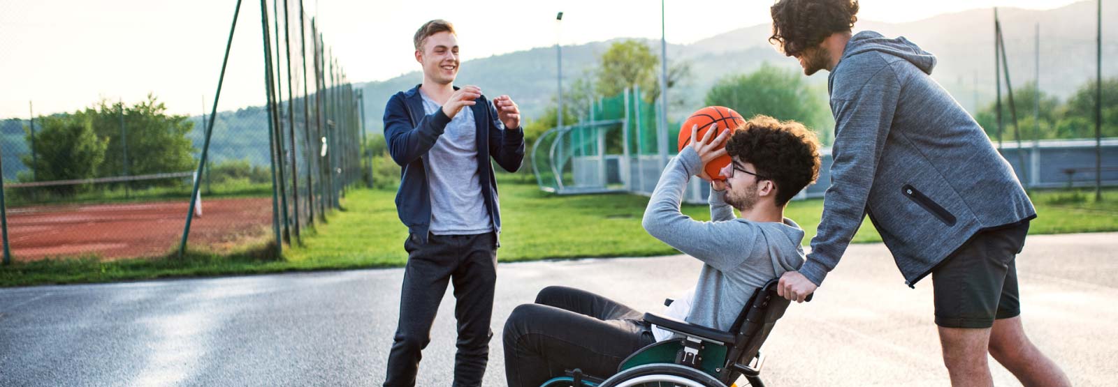 Three friends playing basketball.